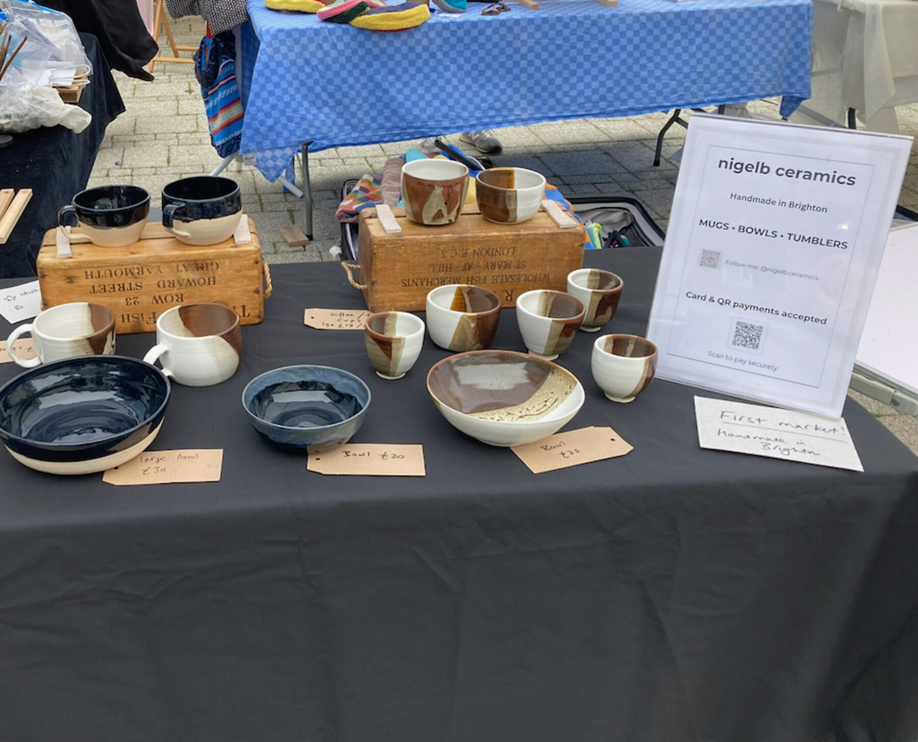 nigelb ceramics stall at a Brighton market, with mugs, bowls and tumblers laid out for sale