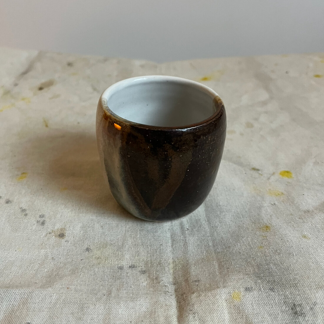 Handmade Amber espresso cup with vertical drips of amber, cream and grey glaze